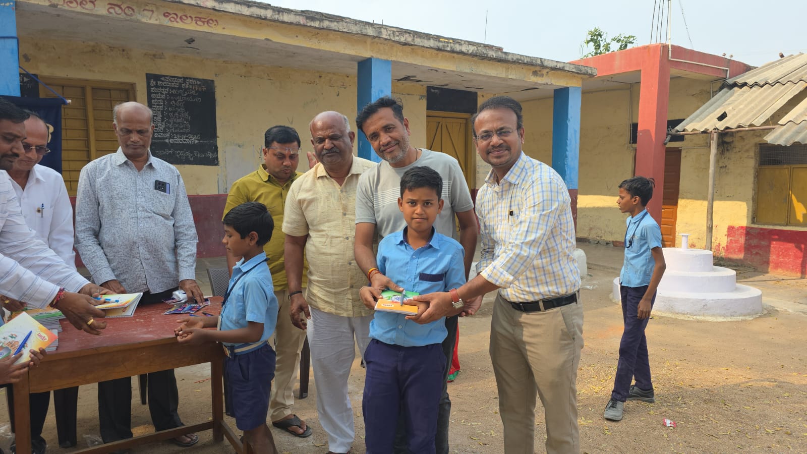Distribution of notebooks and pen to school students 