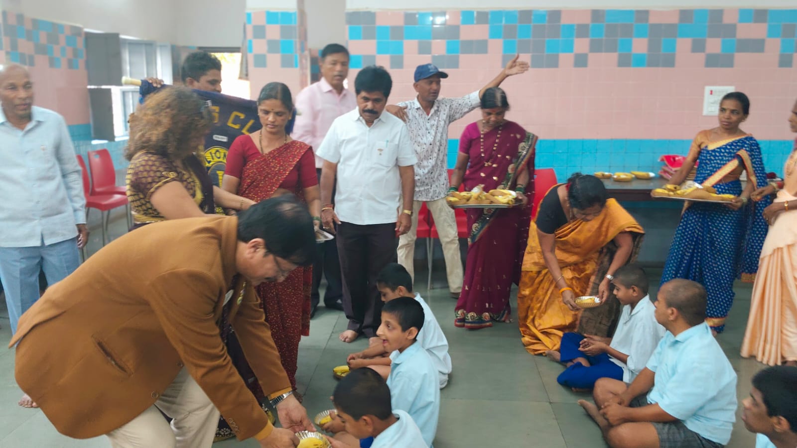 served the prepared food and fruits to mentally retarded school childrens